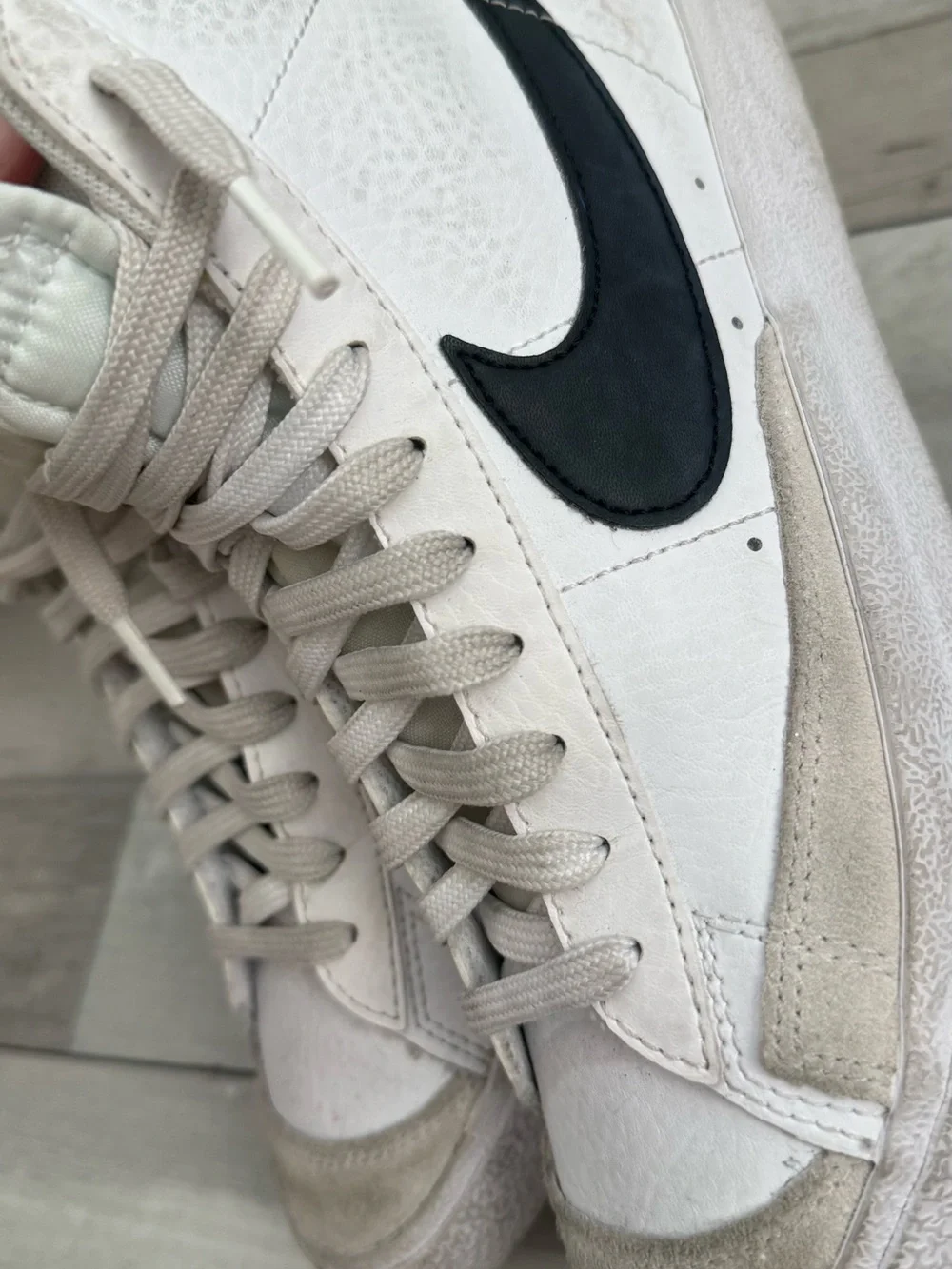 Nike White High-Top Sneakers with Black Swoosh and Orange Tongue Logo